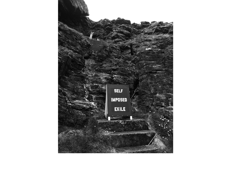 Black and white text A frame text sign on cliff in Cornwall surfing artwork brexit
